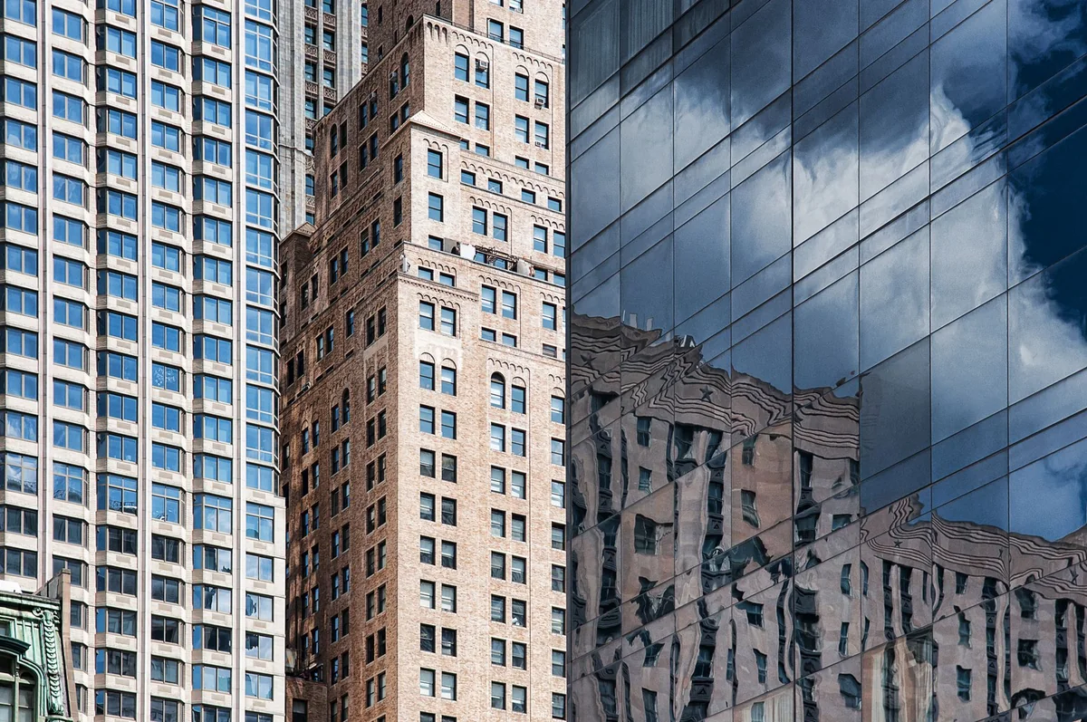 Glass office facades beside a brick building in New York City