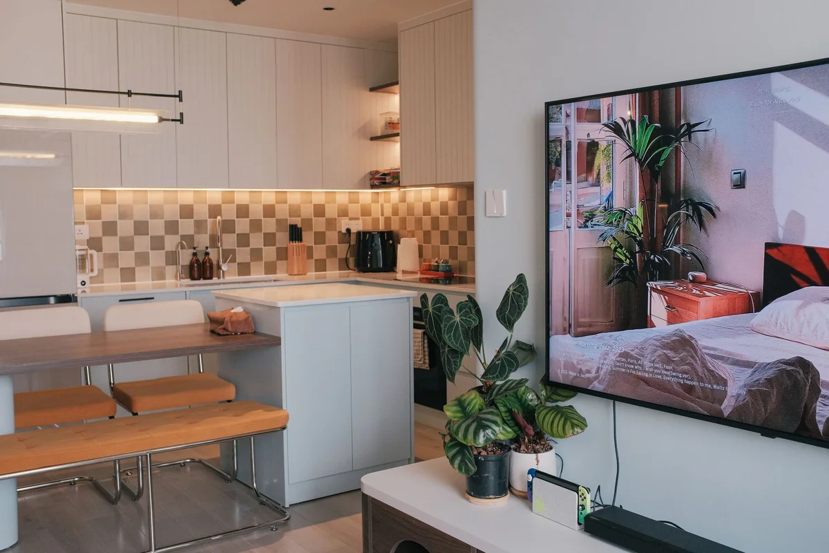 An apartment kitchen opening onto a living room